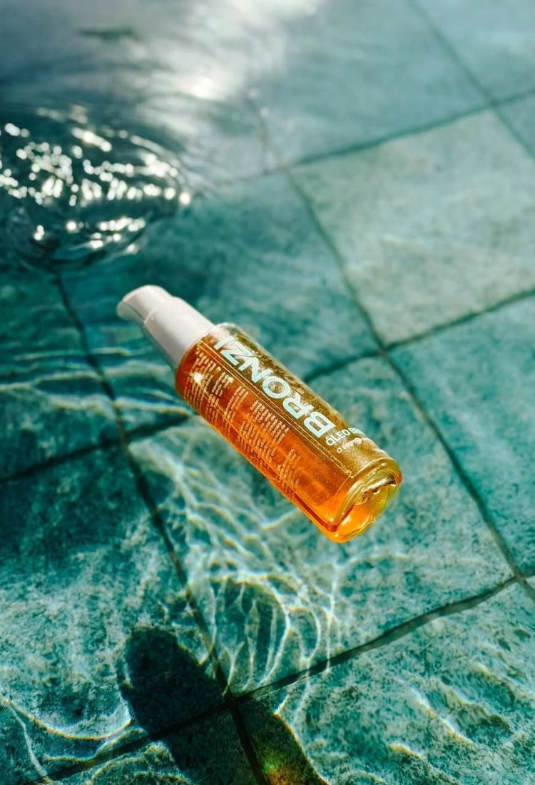 Ritual Solar Bronzi — óleo bronzeador na praia